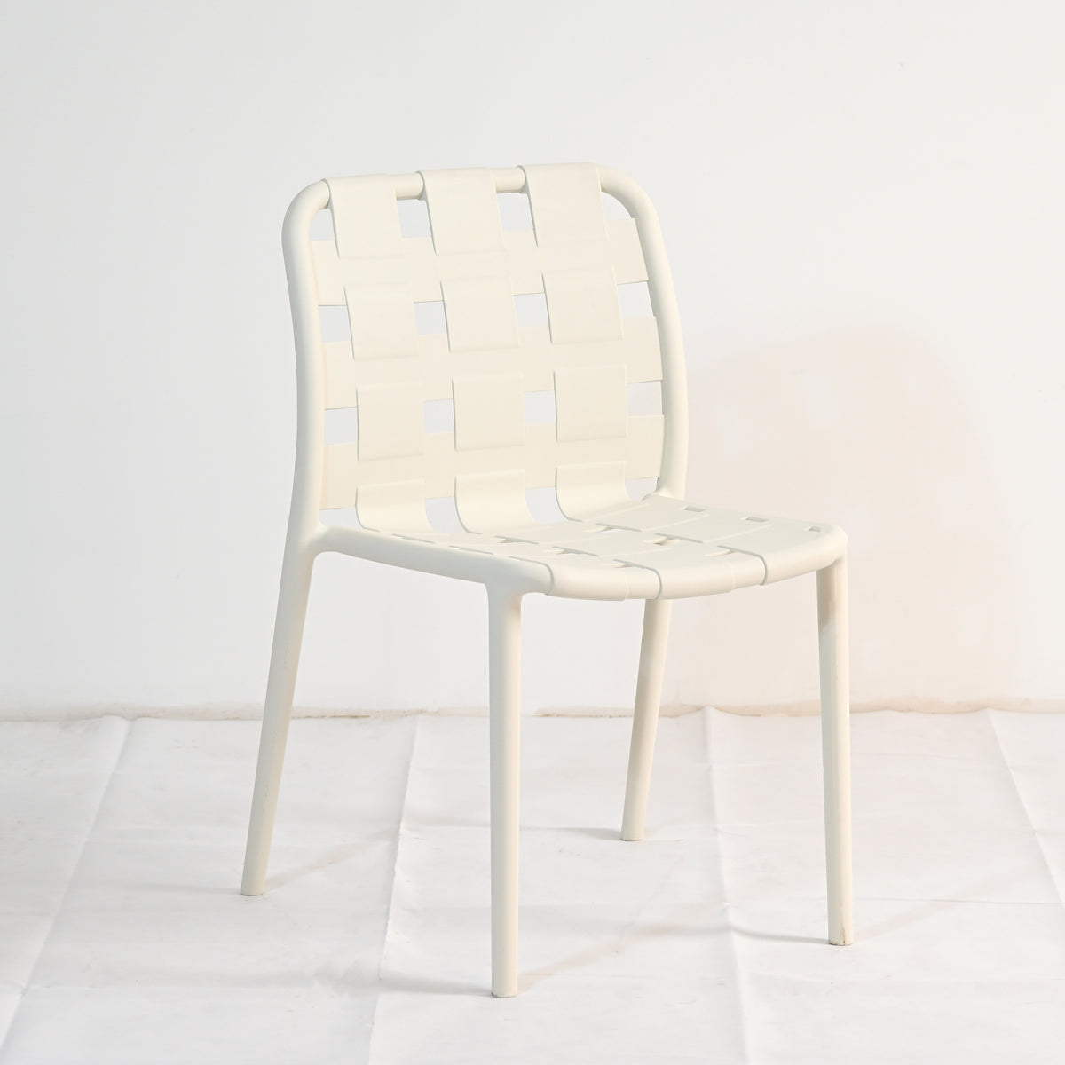 White chair with a woven back design on a white background